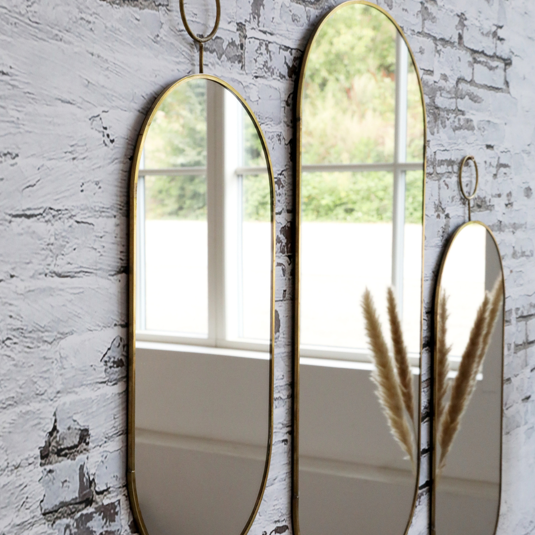 Miroir ovale avec cadre en laiton